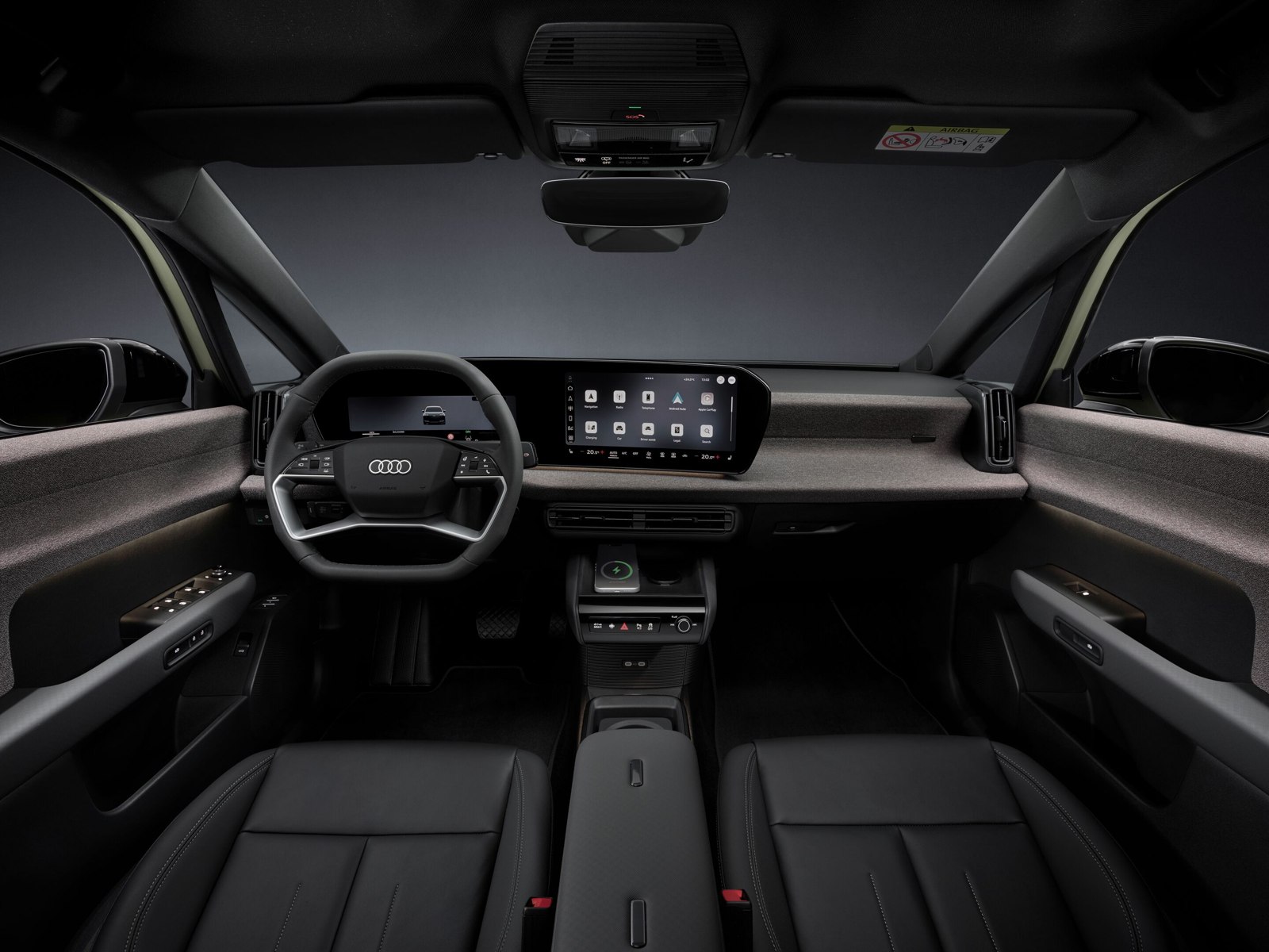 Interieur van de Audi A2 e-tron, gezien vanaf de achterbank naar stuur en dashboard.